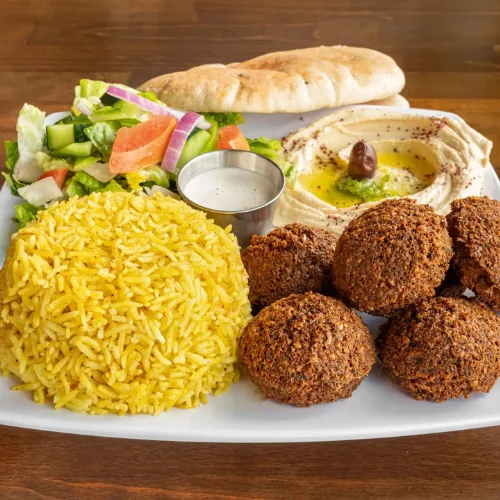 Falafel Plate - Falafel plate served with rice, salad, hummus, and pita bread.