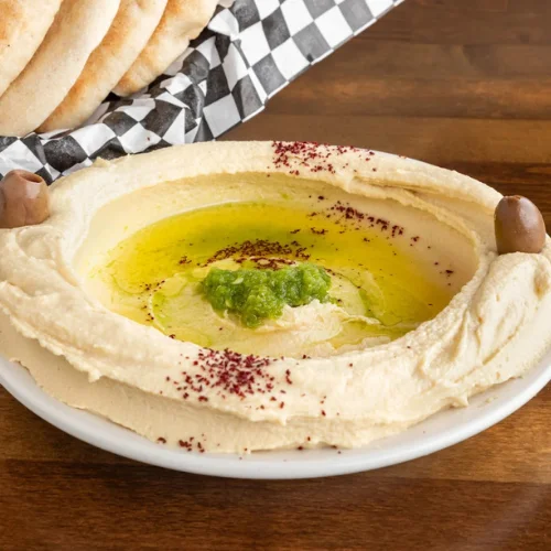 Hummus - Creamy house-made hummus with olive oil and a sprinkle of paprika.