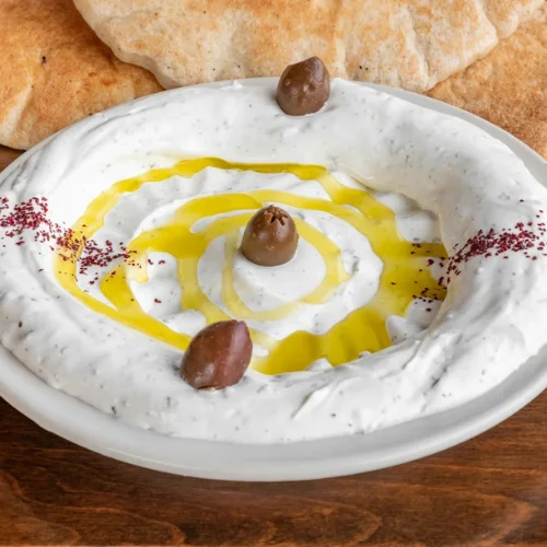 Labneh - Strained yogurt cheese drizzled with olive oil, herbs, and served with pita.
